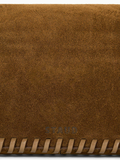 STAUD Harlow Bag in Cigar, a brown suede shoulder bag with whipstitch detailing along the bottom edge.