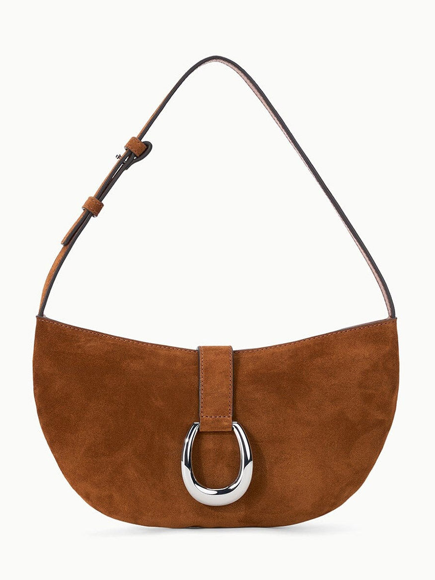 STAUD Harlow Crescent Shoulder Bag in Tabac suede, featuring a single adjustable strap and a large silver moon buckle on the front.