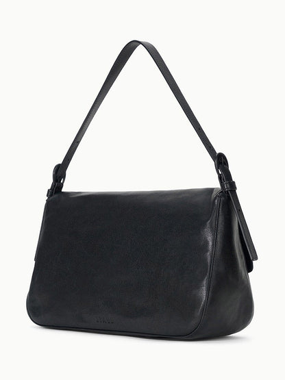 The STAUD Harlow Medium Bag in Black is a rectangular, smooth leather shoulder bag with a single strap and signature Moon buckle, shown against a plain white background.