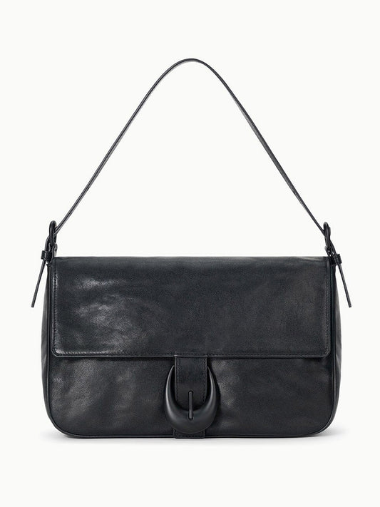 The STAUD Harlow Medium Bag in Black is a rectangular leather shoulder bag featuring a flap closure, single handle, and an elegant moon buckle accent.