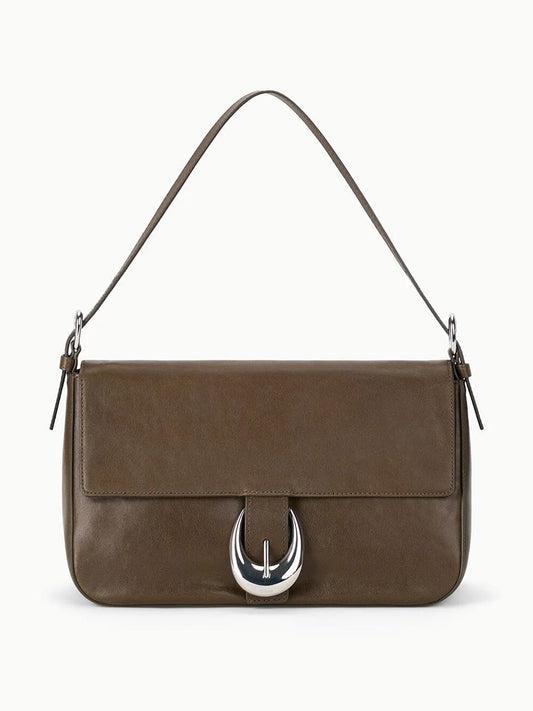The STAUD Harlow Medium Bag in Truffle is a brown leather shoulder bag featuring a short strap, flap closure, and a distinctive Moon buckle on the front.