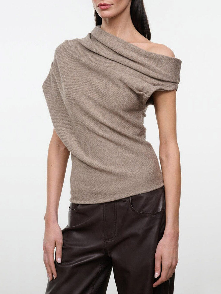 STAUD Mabel Sweater in Sesame, a tan ribbed knit sweater with an asymmetrical, off-the-shoulder neckline and draped silhouette.