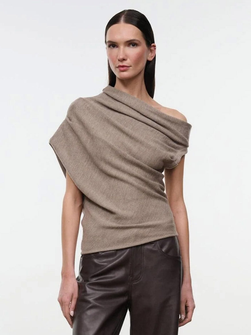 A model wears a tan, off-the-shoulder draped STAUD Mabel Sweater in Sesame.