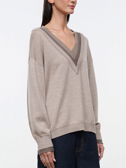 The STAUD Norman Sweater in Sesame Multi is an oversized, tan V-neck sweater featuring a contrasting ribbed hood and a triple-layer neckline.