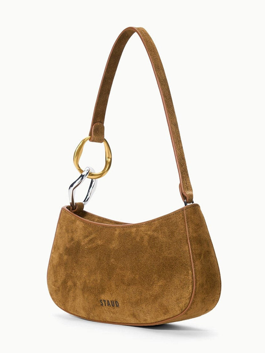STAUD Ollie Bag in Cigar: a compact brown suede shoulder bag with a single strap attached to asymmetrical gold and silver rings.