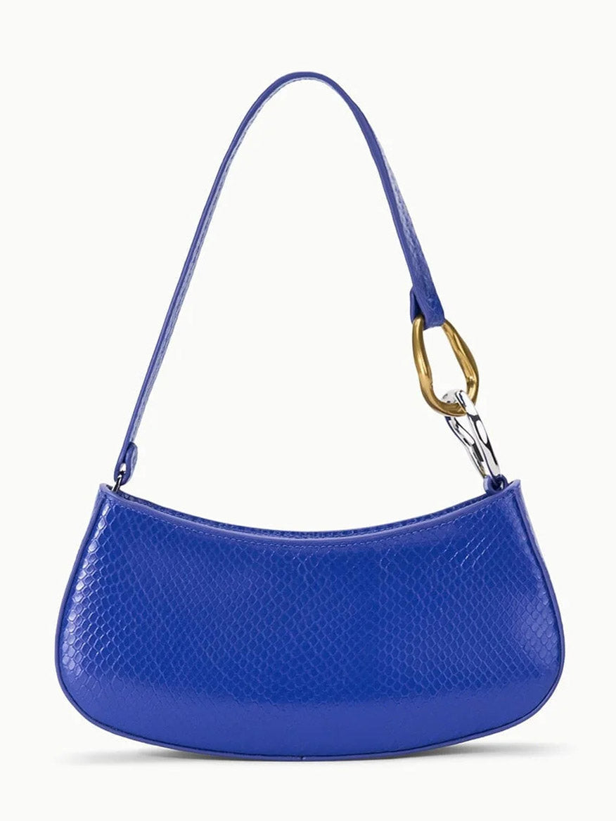 The STAUD Ollie Bag in Cobalt is a blue, textured snake-print leather mini shoulder bag with mixed-metal hardware and a gold and silver clasp, shown on a plain white background.