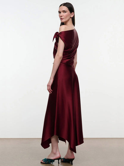 STAUD Portia Silk Dress in Carmino, a dark red midi dress featuring an asymmetrical handkerchief hem and adjustable ties on one shoulder.