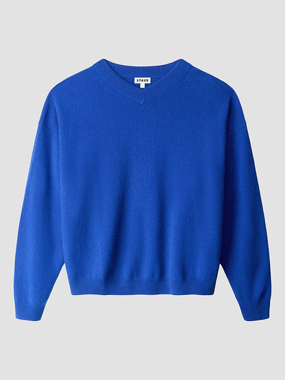 The STAUD Spencer Cashmere Sweater in Cobalt, featuring a relaxed fit, long sleeves, and a classic crew neck, is displayed against a light gray background.