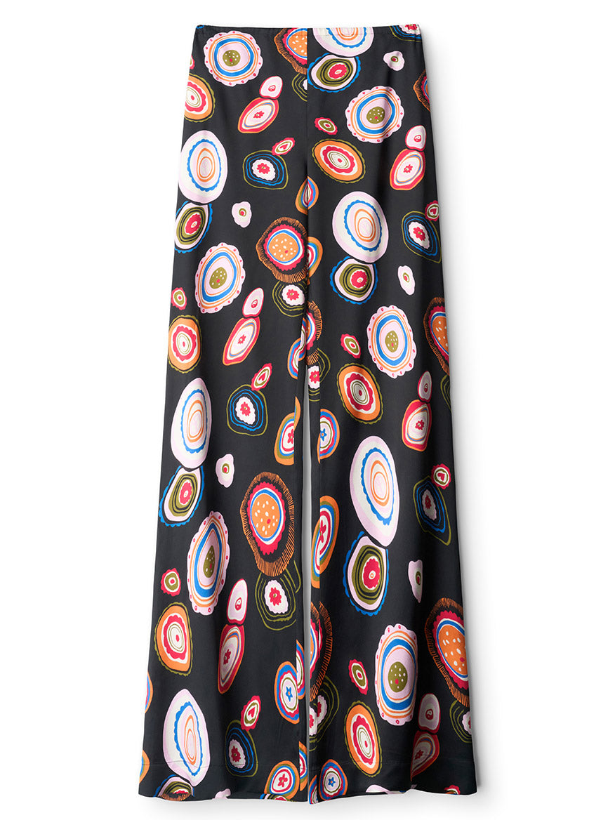 The STAUD Stroll Silk Pant in Millefiore 2.0 is a black straight-leg pant adorned with a repeating print of vibrant, circular abstract motifs, crafted from stretch silk satin and finished with an elastic waistband for extra comfort.
