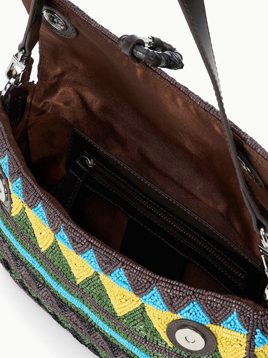 The STAUD Timmy Shoulder Bag in Happy Sack features an open beaded design, a brown satin lining, an interior zip pocket, and magnetic snap closures on the flap.