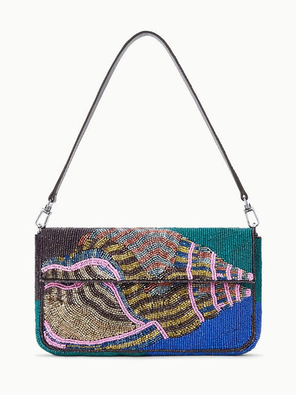 The STAUD Timmy Shoulder Bag in Conch Shell is a rectangular beaded bag with a blue, green, and pink seashell design, a thin black strap, and a secure magnetic closure.