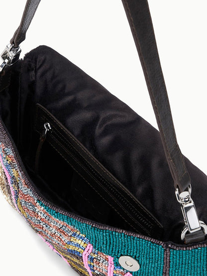 Close-up of the STAUD Timmy Shoulder Bag in Conch Shell featuring an open beaded design, black fabric interior, inner pocket, magnetic closure, and a dark shoulder strap.