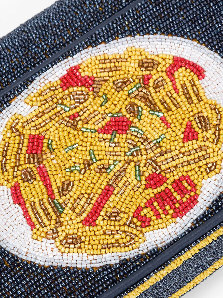 Close-up of the STAUD Tommy Beaded Bag in Staudelloni, featuring a hand-beaded design of a pasta plate with red and green toppings, shown against a white background.
