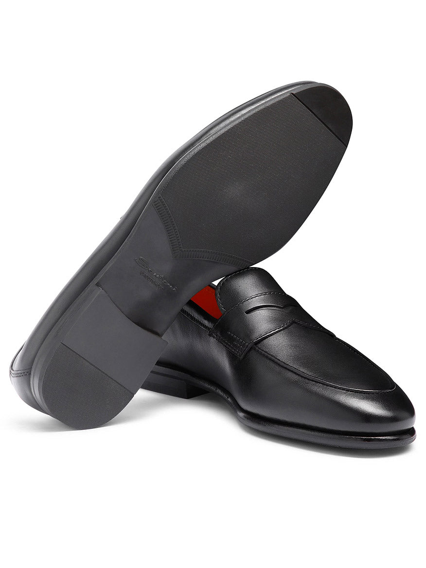 Santoni Carlos Black Leather Penny Loafer, made in Italy, shown with one shoe upright and the other highlighting the sole.