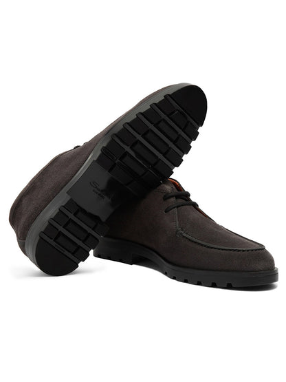 A pair of Santoni Desert Lace Up Boots in grey suede, featuring thick, textured black rubber soles—one boot upright and the other angled to display the sole.