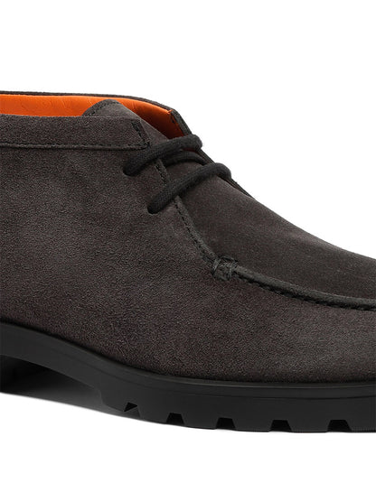 Close-up of the Santoni Desert Lace Up Boot in grey suede, made in Italy, featuring a black rubber sole, visible stitching, and a vibrant orange inner lining.