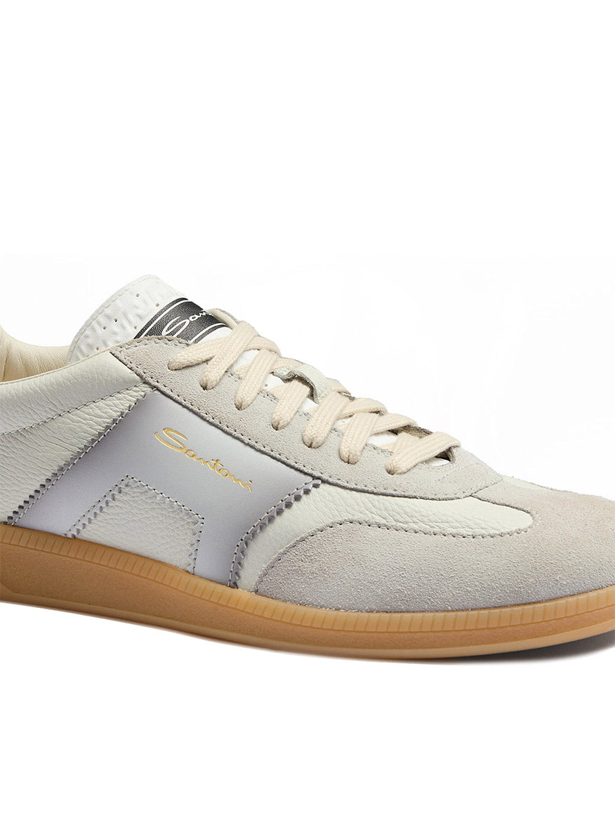 The Santoni Double Buckle Sneaker in White/Blue is a men's leather sneaker with suede and leather panels, gum rubber sole, blue accents, double buckle detail, retro tennis shoe style, and "Santoni" branding on the side.