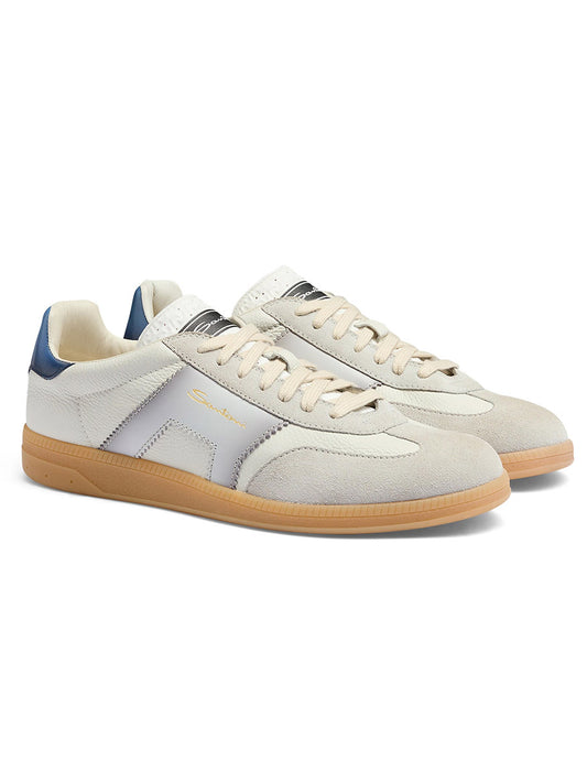 The Santoni Double Buckle Sneaker in White/Blue, featuring a beige and white design with blue heel accents, gum soles, and gold side branding, is displayed on a white background.