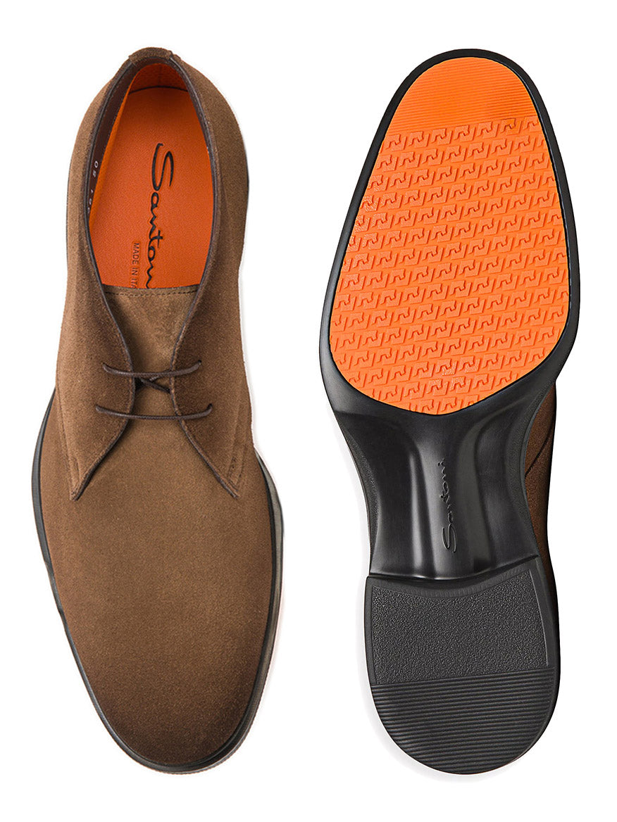 The Santoni Easy Desert Boot, crafted in Italy from burnished brown suede, features striking orange insoles and durable rubber soles. These stylish chukka boots are showcased from the side and bottom.