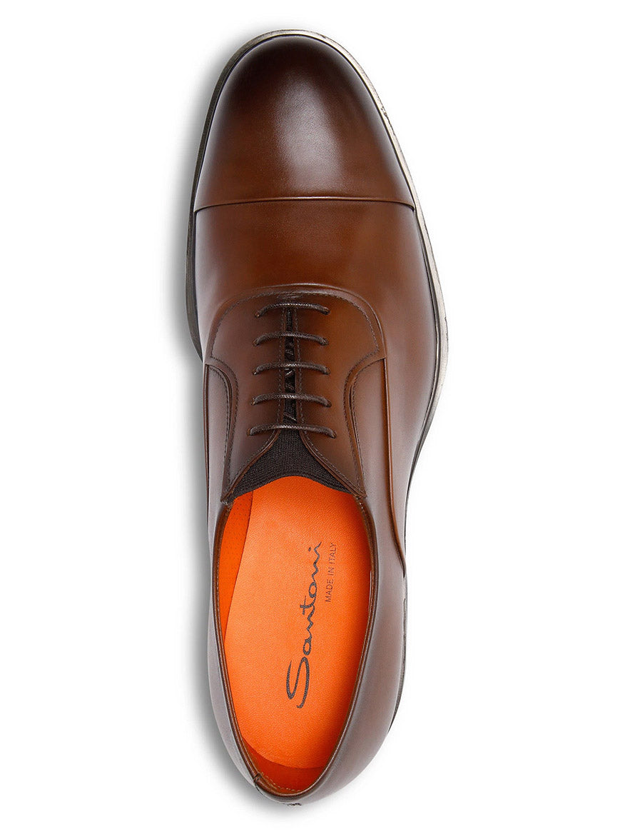 The Santoni Easy Lace-Up Oxford in Dark Brown, shown from above, highlights Italian craftsmanship with a brown leather finish and features an orange insole bearing the Santoni logo.