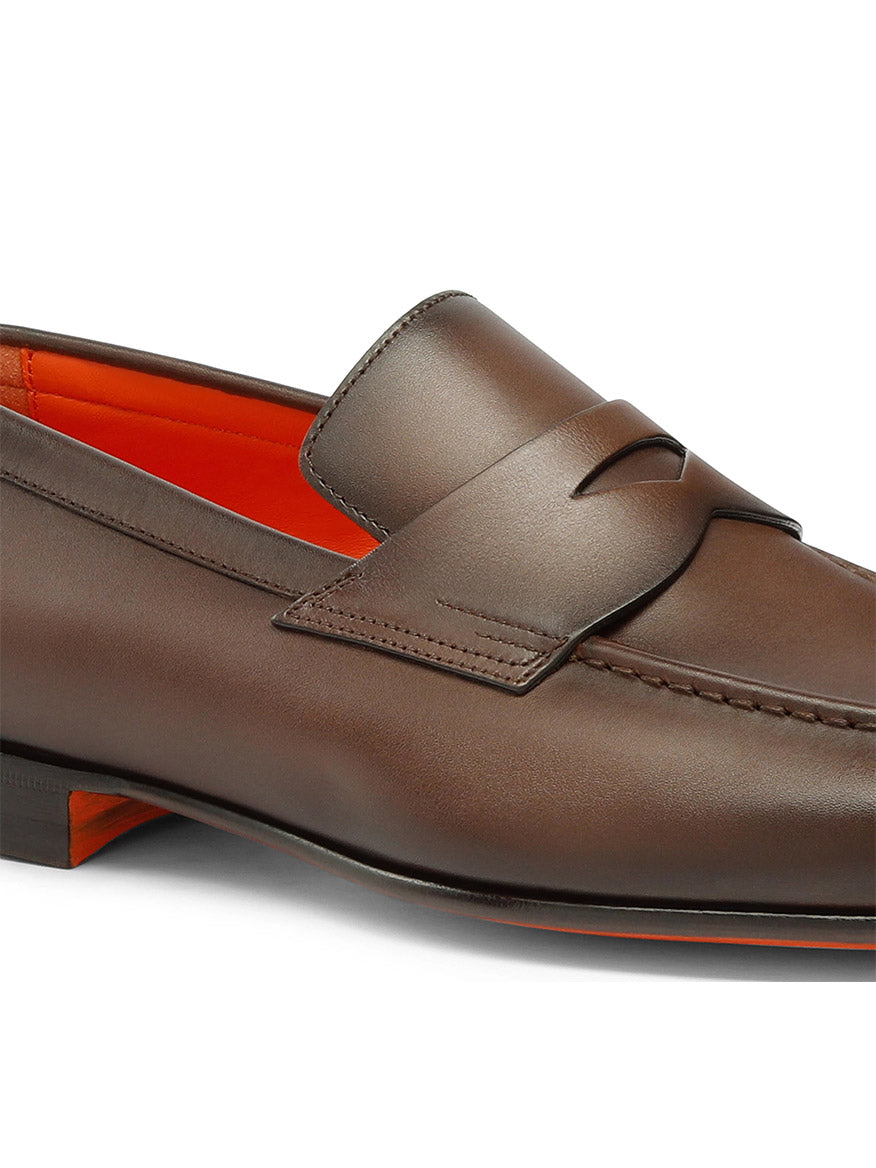 The Santoni Edvin Leather Loafer in brown leather features a decorative strap, artisanal stitch detailing, and an orange interior.