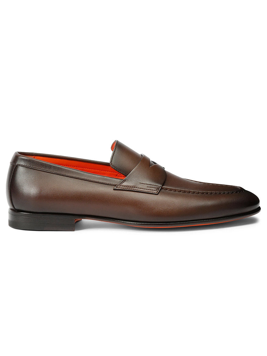 The Santoni Edvin brown leather loafer, featuring a penny strap and red interior, is elegantly showcased against a white background.