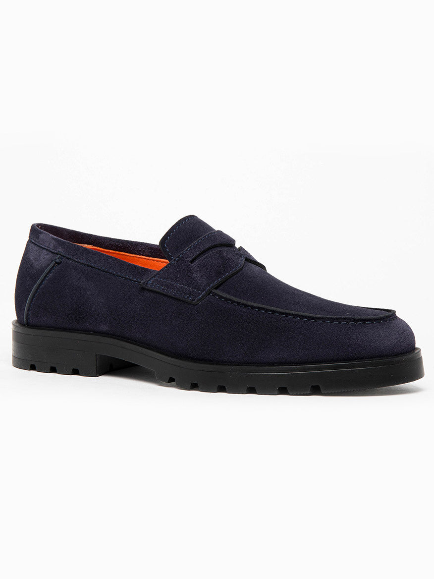 A single Santoni Rock navy suede loafer on a white backdrop, showcasing a black rubber lug sole, orange interior lining, and a penny keeper strap in a slip-on style.