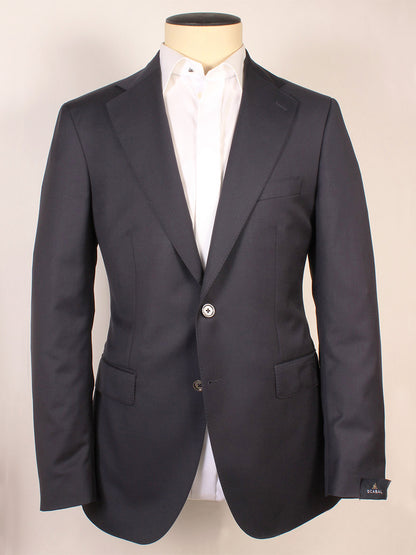 The Scabal Soho Navy Wool Blazer, showcased on a mannequin paired with a white dress shirt, features dark navy wool fabric, notch lapels, two-button closure, and classic flap pockets. This timeless men’s blazer combines sophistication with versatility, making it an ideal choice for both formal occasions and smart-casual ensembles.