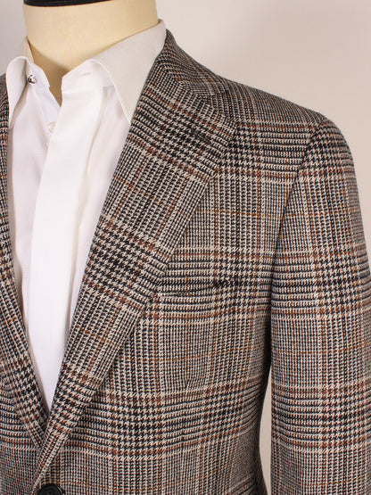 Close-up of a person wearing a white dress shirt and the Scabal Soho Glenn Plaid Sport Jacket in Black/Brown, featuring a notched lapel.