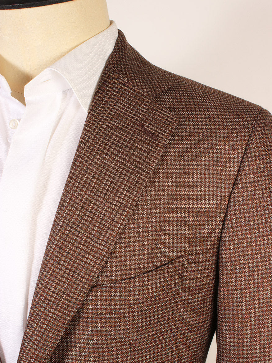 Close-up of a mannequin dressed in the Scabal Soho Houndstooth Sport Jacket in Brown over a white dress shirt, highlighting the lapel and chest pocket of this classic men’s blazer.