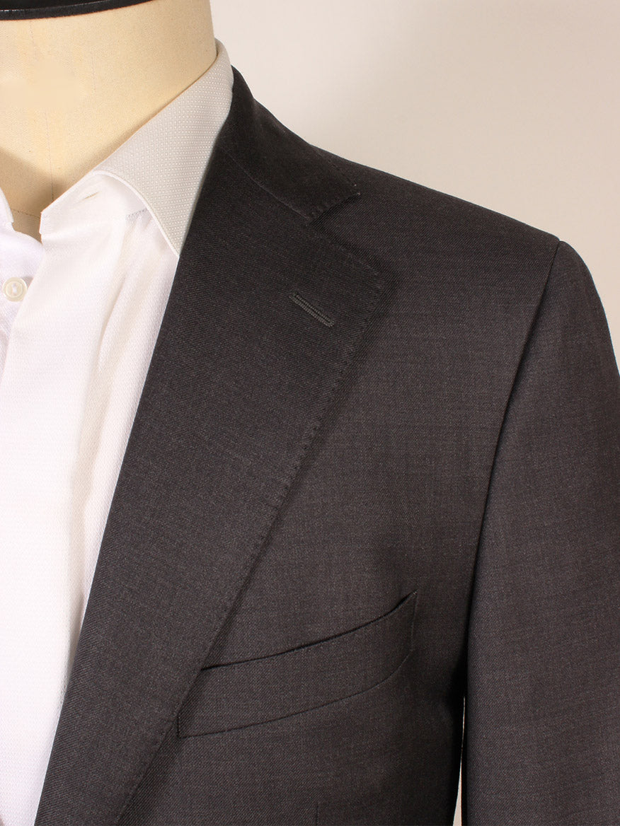 Close-up of a person wearing the Scabal Soho Wool Suit in Charcoal over a white dress shirt, highlighting the lapel, collar, and chest pocket. This classic 2-button suit is expertly made in Portugal.