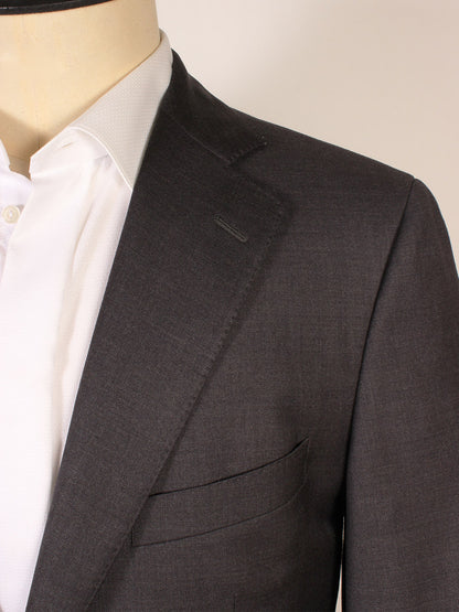 Close-up of a person wearing the Scabal Soho Wool Suit in Charcoal over a white dress shirt, highlighting the lapel, collar, and chest pocket. This classic 2-button suit is expertly made in Portugal.