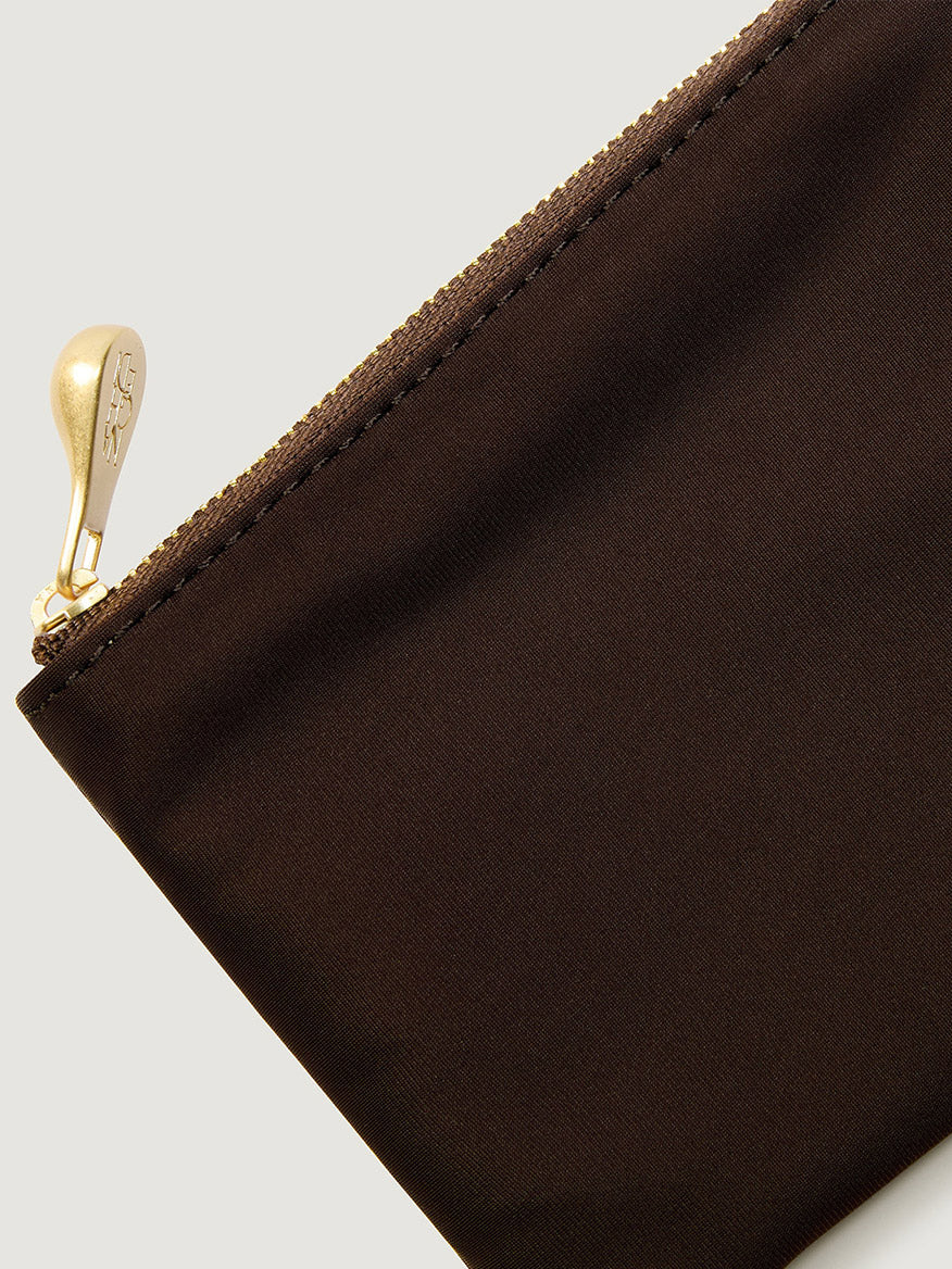 A dark brown Naghedi St. Barths Petit Tote Nest Weave in Chocolate mini bag with a gold-toned zipper pull.