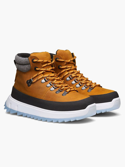 Introducing the Swims Fjell Boot in Blaze: a pair of tan waterproof leather hiking boots with black toe caps, white lug soles, and eye-catching orange laces that provide excellent insulation for all your outdoor adventures.