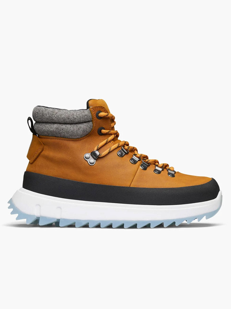 The Swims Fjell Boot in Blaze is a yellow and black hiking boot with a thick white sole, made from waterproof leather. It includes metal eyelets and gray padded ankle support for enhanced comfort and insulation, shown against a plain white background.