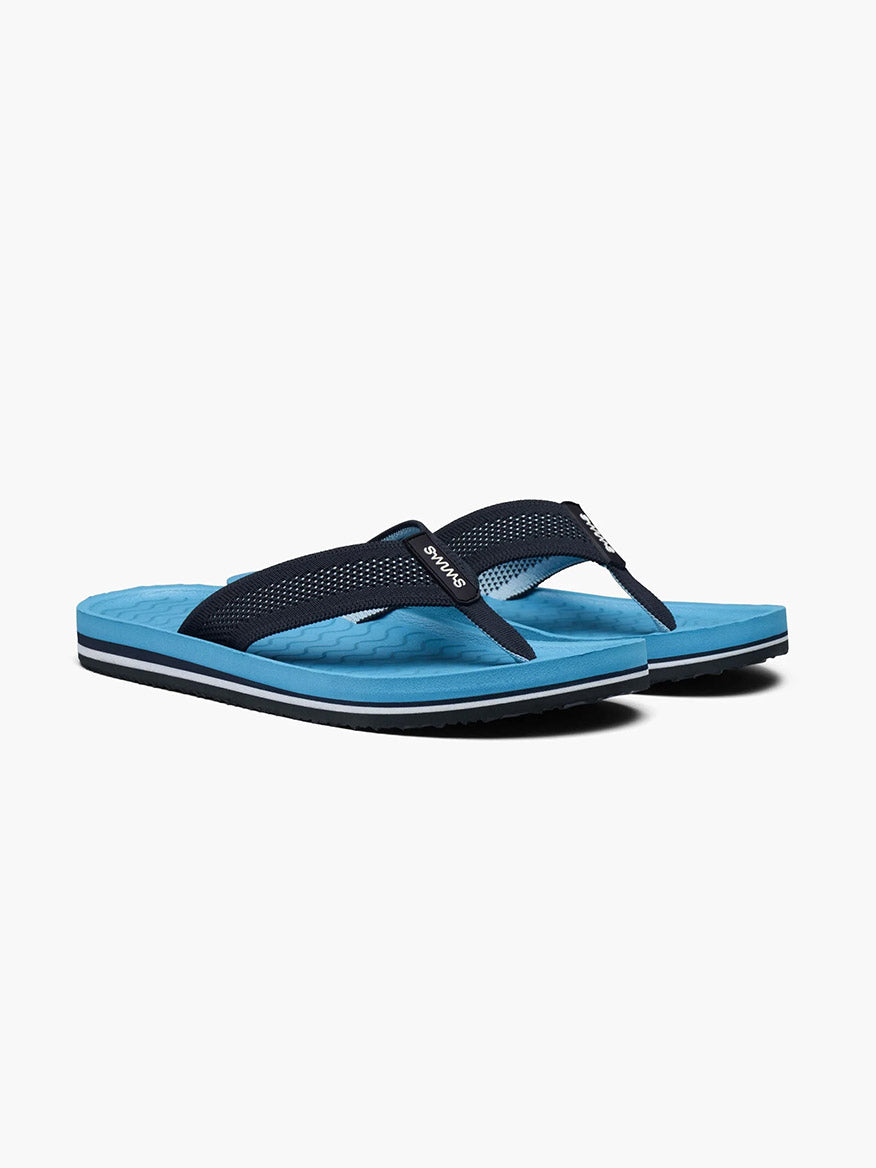 A pair of Swims Napoli flip-flops in Aegean Blue with black straps and arch support on a white background.