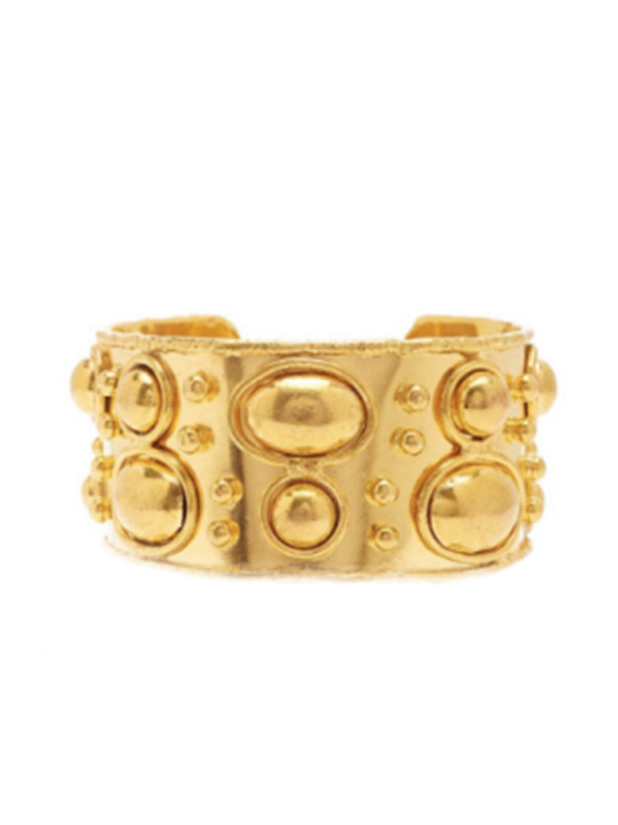 A wide, brass gilded gold-colored ring featuring embossed circular and oval designs, Sylvia Toledano Cuff Byzantine in Gold.