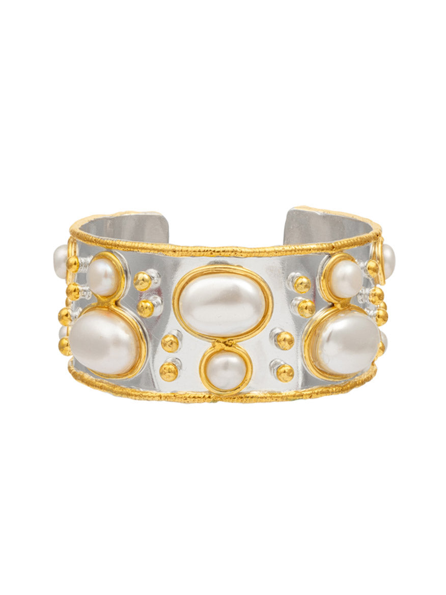 The Sylvia Toledano Cuff Byzantine in Silver Pearl is a stunning wide silver band bracelet, elegantly adorned with large oval and round white pearls, and accented by small gold beads.