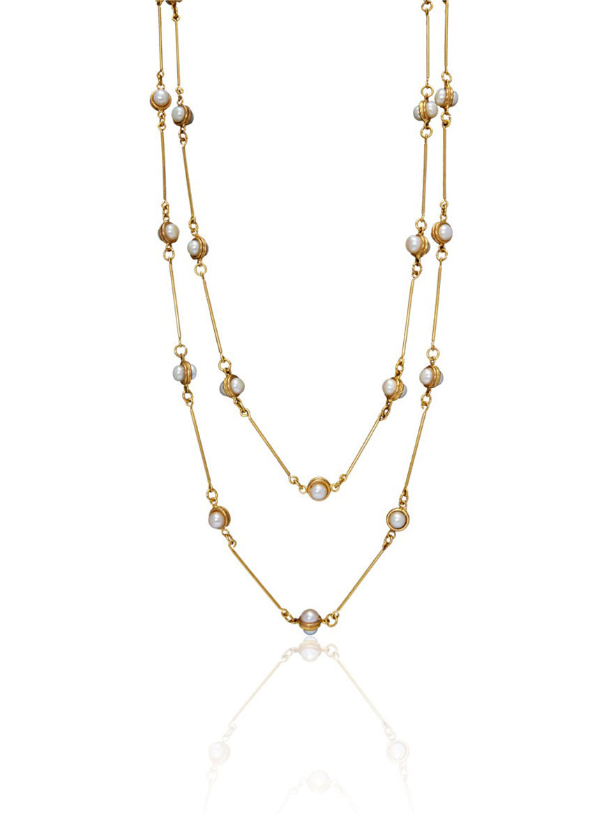 Introducing the Sylvia Toledano Necklace Pendant Candies in Pearl, a double-layered fine gold creation adorned with dainty pearl accents evenly spaced along both chains.