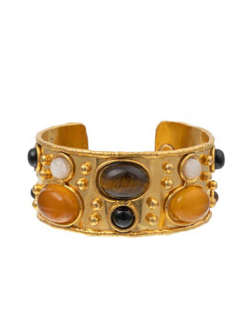 The Sylvia Toledano Cuff Byzantine in Feline Mix features intricate brass gilding with fine gold, adorned with polished stones in vibrant orange and cream hues, and highlighted by a striking black onyx centerpiece.