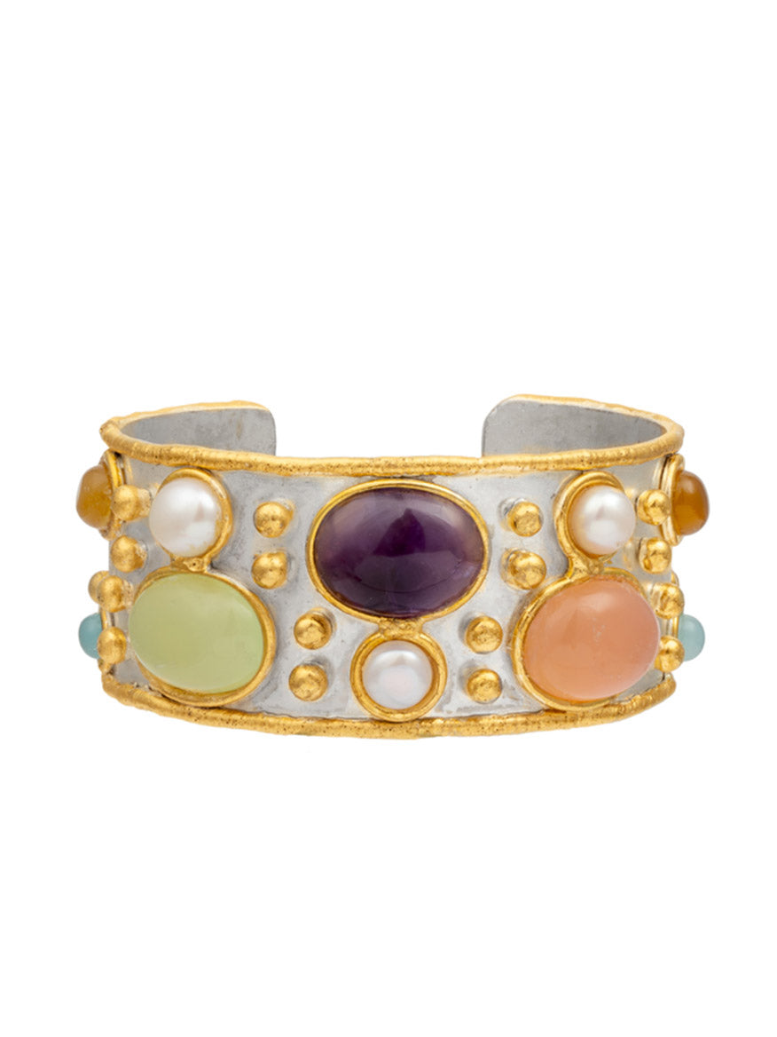 Introducing the Sylvia Toledano Cuff Byzantine, a exquisite piece crafted in a combination of gold and silver. This cuff bracelet is adorned with large, colorful gemstones such as radiant amethyst, alongside pink quartz and green pale onyx, all beautifully accented with small pearls.