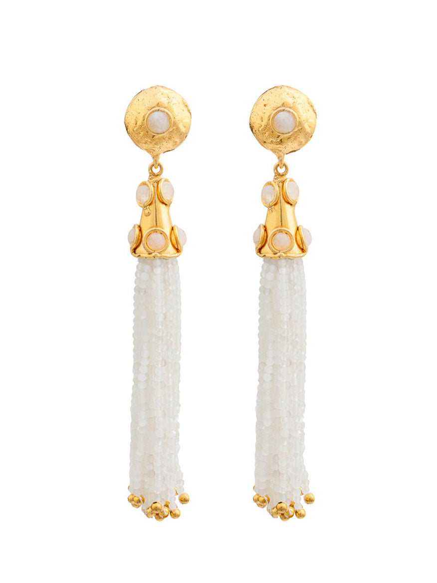 Introducing the Sylvia Toledano Earrings Gio in Moonstone: a pair of brass gilded with fine gold earrings featuring a round stud adorned with moonstones and long tassels made of small white beads.