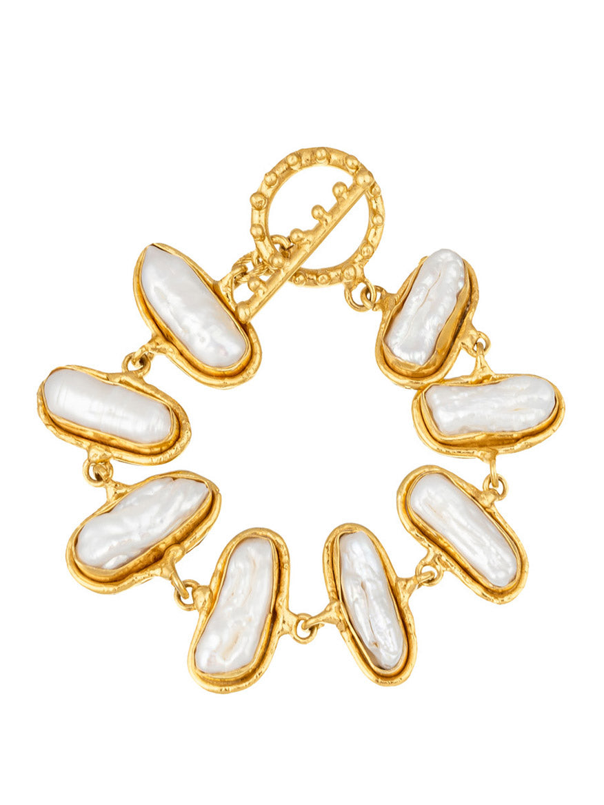 A Sylvia Toledano Bracelet Grace in Gold & Baroque Pearl featuring seven baroque pearls linked together in a circle with a decorative clasp at the top.