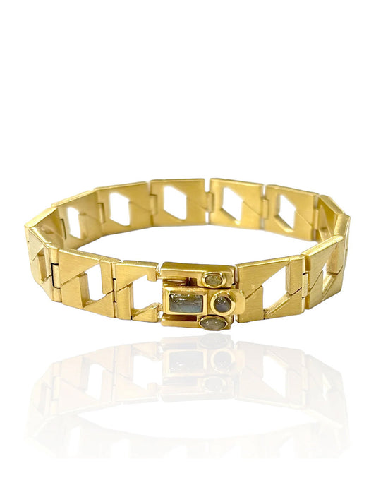 The Tat2 Designs Labradorite Piatta Chain Bracelet in Gold showcases geometric gold-plated links, circular and rectangular gemstone accents including a labradorite cabochon, all displayed on a white background with a subtle reflection.