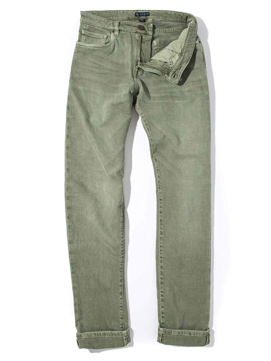 The Teleria Zed Cobra Selvedge Stretch Denim in Menta, featuring a partially unbuttoned fly and rolled cuffs, is displayed flat on a white background.