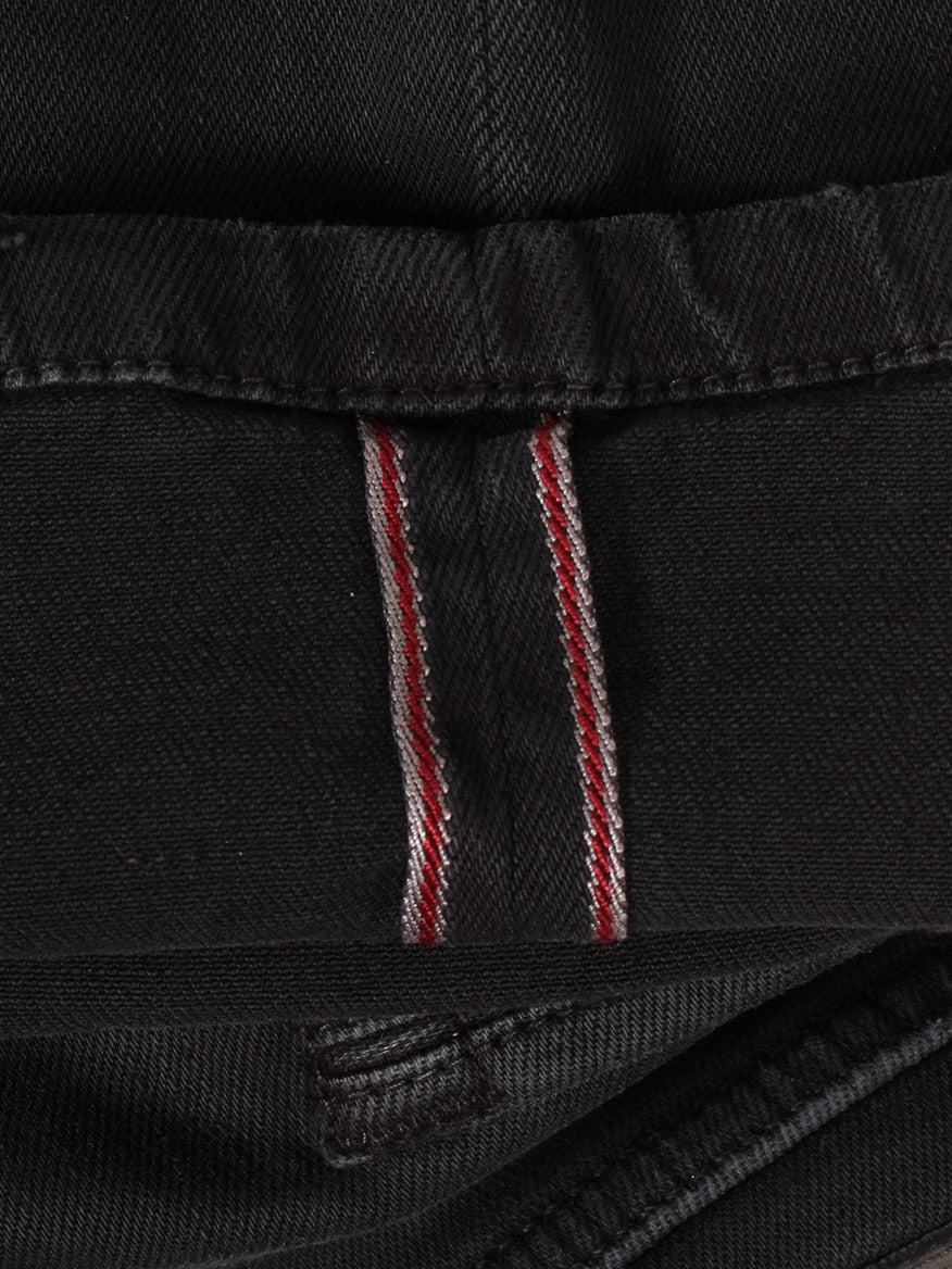 Close-up of Teleria Zed Cobra Selvedge Stretch Denim in Nero, featuring a visible red and white Cobra Selvedge seam, expertly crafted in Italy.