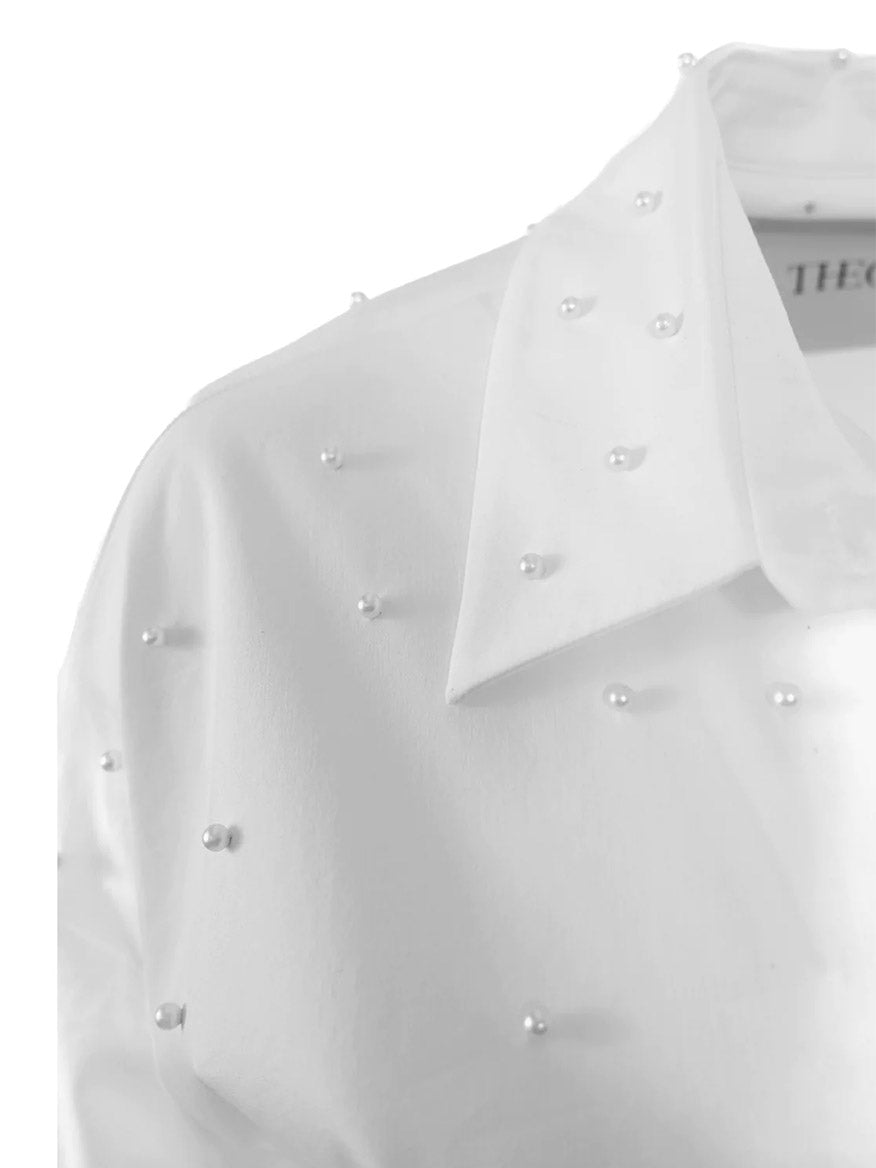 Close-up of THEO The Label Echo Pearly Shirt in White, featuring pearl details on the collar and front button down shirt.