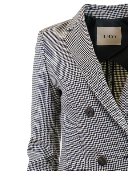 Close-up of a THEO The Label Eris Baby Houndstooth Blazer in Black/Ivory with buttons.