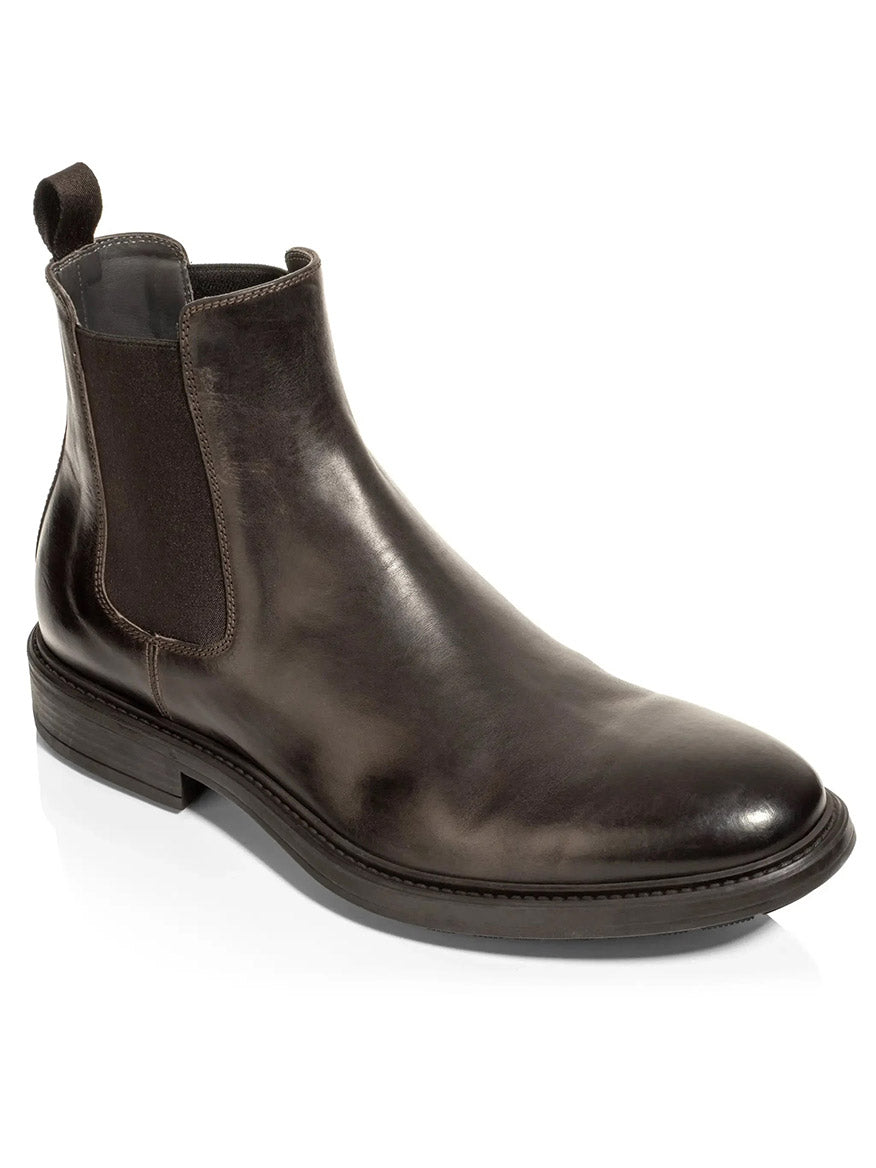 The To Boot New York Largo Chelsea Boot in Moro is a single dark brown Chelsea boot, handcrafted in Italy from supple Italian calf leather, featuring elastic side panels, a pull tab at the back, and a low stacked heel—all showcased against a white background.