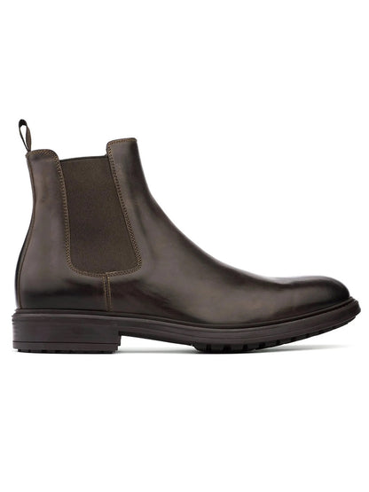 The To Boot New York Largo Chelsea Boot in Moro is a brown leather Chelsea boot, handcrafted in Italy, featuring a round toe, elastic side panel, and pull tab at the back. It is shown in a left side profile against a white background.